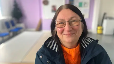 Photograph of Sue Bredbury from Reddish. She is pictured in the social supermarket in Reddish. 