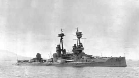 Orkney Library and Archive A black and white photo of a World War one warship with two two guns and two turrets.