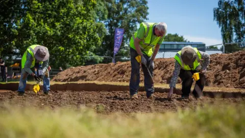 James Dobson/National Trust A team from FAS Heritage working in the the trench in Garden Field in Sutton Hoo