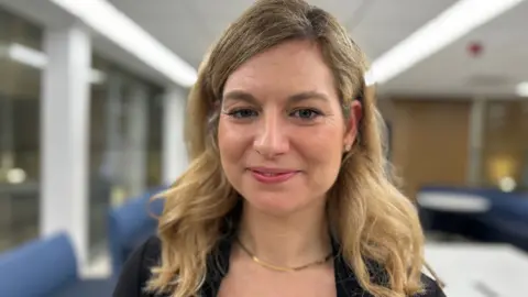  Barbora Gray has long blonde hair and smiles 