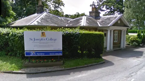 Google The front entrance to St Joseph's College. A sign saying 'St Joseph's College' can be seen on the left of the image