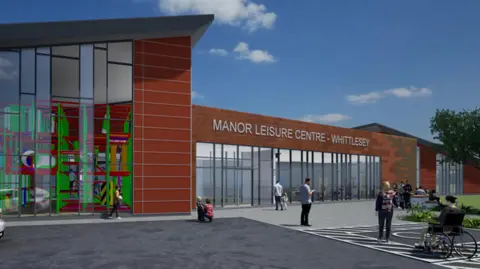 Fenland District Council Artist's impression of the centre - which looks like a brown building with a glass frontage with silver signage saying " Manor Leisure Centre - Whittlesey".