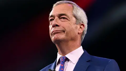Getty Images Nigel Farage looking off camera against a dark background