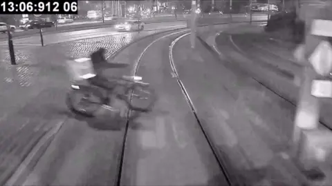 A cyclist on a tram track