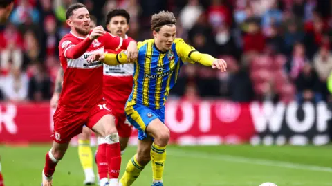 Caspar Jander rides a tackle as he runs with the ball for Southampton