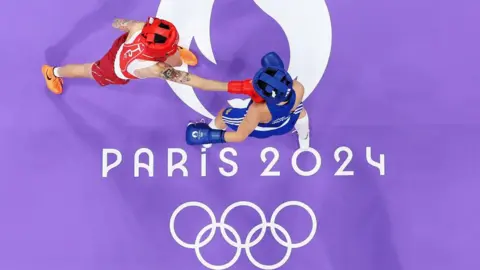 Hsiao Wen Huang of Team Chinese Taipei punches Bojana Gojkovic of Team Montenegro during the Women's 54kg preliminary round match at the Olympic Games Paris 2024