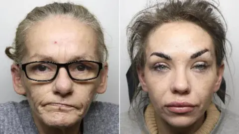 Two mugshots side by side. On the left is an older looking woman with narrow black glasses, a grey cardigan and greying hair tied up. On the right is a woman with brown hair tied up with a ribbon which is visible from the front. She has thin dark eyebrows and blue eyes, and has lip filler.