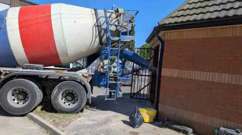 Supplied Truck supplying concrete into a toilet building in Ilkeston