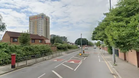 Google A post box on the right in Marsh Lane with traffic calming measures in the tree-lined street