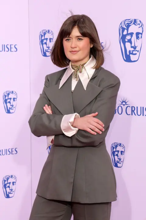 Getty Images Ella Bruccoleri in a grey suit