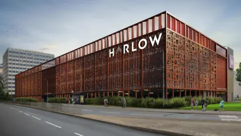 Harlow Council A graphic image of a building that has been covered in a bronze-brown facade with a big log saying Harlow on it. It is next to a dual carriageway.