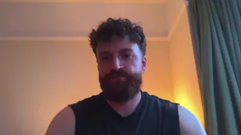 A man in a black vest