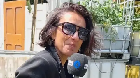 Anita Rani with a microphone