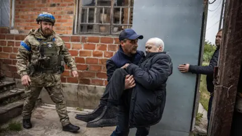 Getty Images Police evacuate civilians in the Kharkiv region