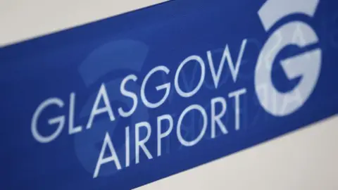 A sign showing the Glasgow airport logo