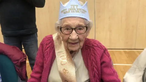 Ivy Kimber wears a birthday crown and sash at her birthday party in Somersham 