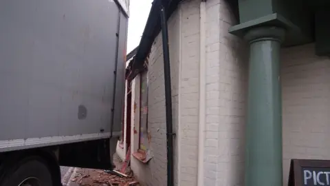 Nigel Emery / Nifty Gallery Smashed tiles on the pavement due to a lorry hitting a business