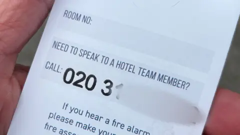 Wendy Griffth A Travelodge key card holder which is showing a phone number for staff