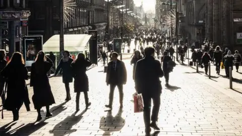 A sunlit view of Buchanan Street in Glasgow.