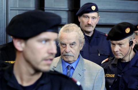 Josef Fritzl surrounded by police officers 
