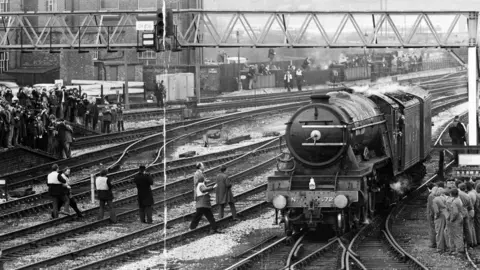 Getty Images Steam locomotive Flying Scotsman 4472 arrives to cheers from waiting crowd in Derby, England, in 1973