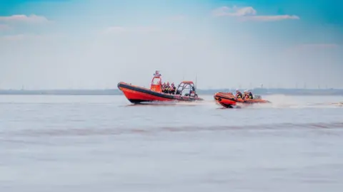 Humber Rescue Two rescue boats pictured in the Humber Estuary. One is larger than the other, and both appear to be moving quickly due to the spray around the vessels.