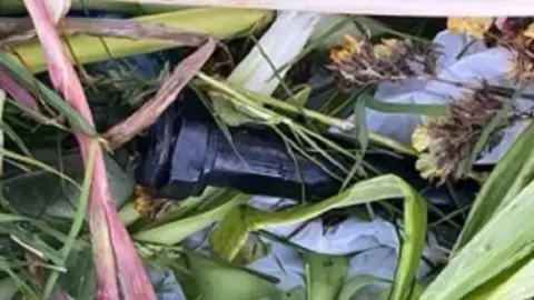 PSNI Shows a suspected pipe bomb in foliage