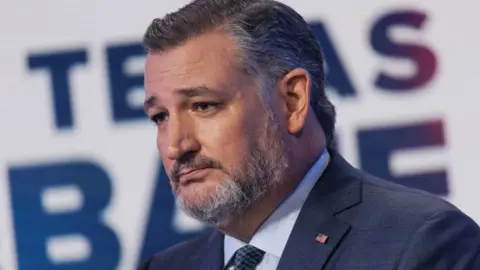 A closeup photo of Texas Senator Ted Cruz, who is wearing a blue suit