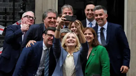 Reuters A group of regional mayors lining up for a selfie on the doorstep of Downing Street