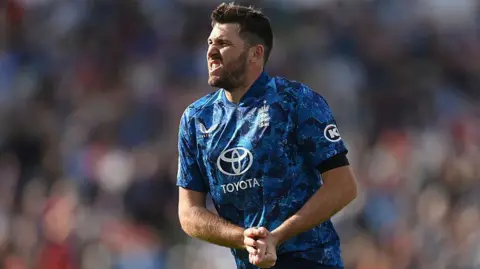 Jamie Overton grimaces in pain