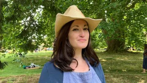 Sam Read/BBC Rachel Constantine in front of the plane tree