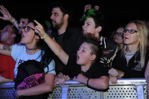 Dod Morrison Teenagers and a child punk in the moshpit at the Rebellion festival