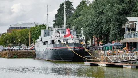 Plaster A view from the water of the bow of the Thekla Boat, painted in black, red and grey colours 