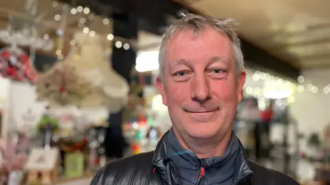 Older man with short hair in a shop