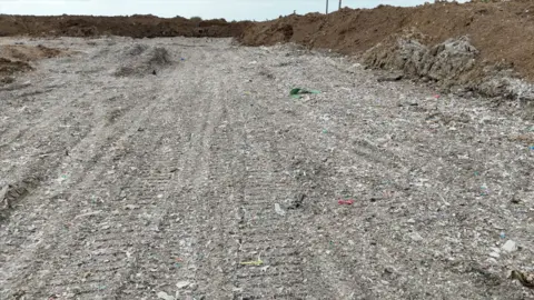 Shredded plastic can be seen in the waste