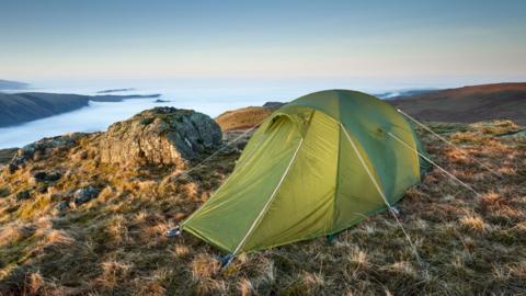 A green tent on a fell