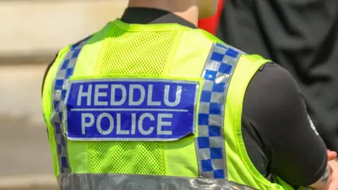 Getty Images Back of police officer with HEDDLU POLICE visible on uniform