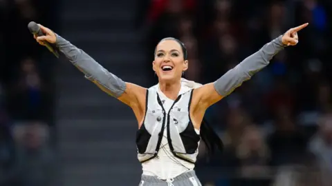 Katy Perry points her hands up at a crows as she performs at the Invictus Games in Vancouver.