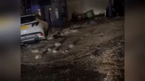 Gail Abbie Videos on social media shows a street swamped in mud