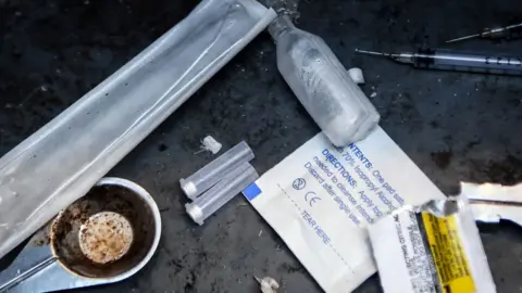 Getty Images has been ignored by drug tools, including syringes and small plastic tubes, in the lane in Glasgow.