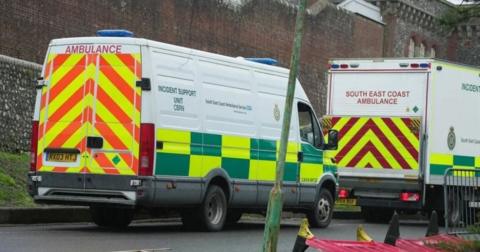 Two ambulance vehicles, including one chemical support unit, parked outside the walls of Lewes Prison on Thursday