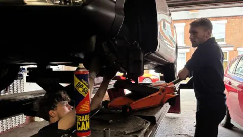 Mechanics working on a car