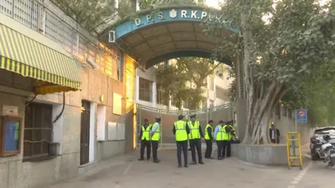 ANI Security officials are standing outside Delhi Public School, RK Puram, which was among the schools that received a bomb threat email on 8 December.