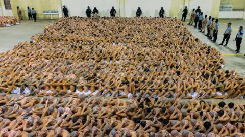 Reuters A photo provided by the government of El Salvador shows hundreds of prisoners crowded together in Cecot prison