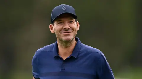 Romo seen wearing a hat outside while golfing