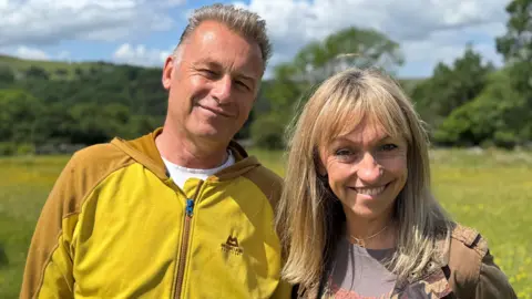 Chris Packham and Michaela Strachan in a field 