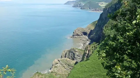 A wide shot of cliffs and the sea on the South West Coast Path in Somerset