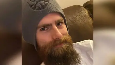 Police Scotland Calum Rae, a man with a beard smiling at the camera.