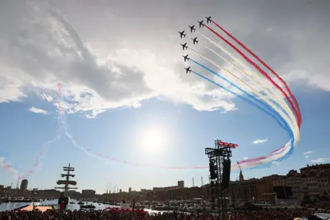 Denis Balibouse/Reuters Planes fly in the air as the Olympic Flame arrives in Marseille