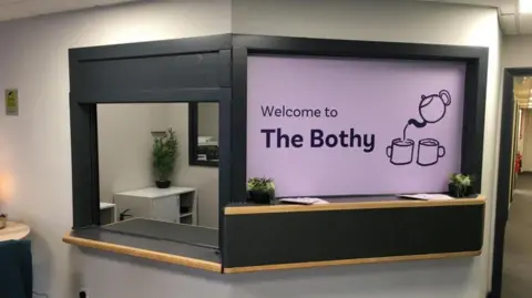 The reception area of The Bothy in Ashington showing a sign saying Welcome and a picture of a pot and two cups of tea.